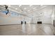 Spacious indoor gymnasium equipped with basketball hoops, a pristine hardwood floor, and ample natural light for fitness activities at 15716 Barefoot Beach Dr, Bradenton, FL 34211