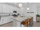 Bright kitchen with white cabinets, granite countertops, stainless steel appliances, and a breakfast bar at 15716 Barefoot Beach Dr, Bradenton, FL 34211