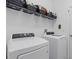 Functional laundry room with a washer, dryer, and ample storage space at 15716 Barefoot Beach Dr, Bradenton, FL 34211