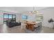 Open-concept living and dining area with modern furnishings and natural light at 15716 Barefoot Beach Dr, Bradenton, FL 34211