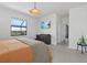 Bright main bedroom with large window offering picturesque outdoor views and relaxing decor at 15716 Barefoot Beach Dr, Bradenton, FL 34211