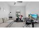 Functional office space includes a sofa, desk, and exercise equipment for comfortable work/workouts at 15716 Barefoot Beach Dr, Bradenton, FL 34211
