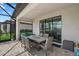 Screened outdoor dining area for al fresco meals and gatherings with ample seating at 15716 Barefoot Beach Dr, Bradenton, FL 34211