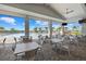 Spacious patio with tables, seating, and views of the pool and palm trees at 15716 Barefoot Beach Dr, Bradenton, FL 34211