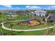 Bright playground featuring slides and swings, perfect for fun and located near other community amenities at 15716 Barefoot Beach Dr, Bradenton, FL 34211