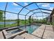 Stunning pool and spa with a screened enclosure overlooking a serene lake at 15716 Barefoot Beach Dr, Bradenton, FL 34211