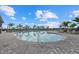 Large outdoor pool surrounded by palm trees, lounge chairs and a paved patio at 15716 Barefoot Beach Dr, Bradenton, FL 34211