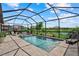 Inviting screened-in pool area with ample seating and scenic lake views at 15716 Barefoot Beach Dr, Bradenton, FL 34211