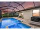 Sparkling pool and spa within a screened enclosure create a private oasis at 15716 Barefoot Beach Dr, Bradenton, FL 34211