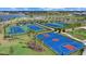 Aerial view showcasing multiple tennis courts and a basketball court, all immaculately maintained within the community at 15716 Barefoot Beach Dr, Bradenton, FL 34211