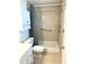 Clean bathroom with a walk-in shower, grab bars, single vanity, and cabinet storage at 1604 Chevy Chase Dr, Sun City Center, FL 33573