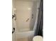 Bathroom showing a shower/tub combination with a hand rail and shower curtain at 1604 Chevy Chase Dr, Sun City Center, FL 33573