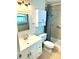 Clean bathroom featuring a single vanity, toilet, and a walk-in shower with grab bars at 1604 Chevy Chase Dr, Sun City Center, FL 33573