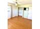 Bedroom featuring laminate flooring, a ceiling fan, and a closet with convenient shelving at 1604 Chevy Chase Dr, Sun City Center, FL 33573