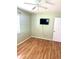 This is a cozy bedroom with a ceiling fan, a mounted TV, and light green walls at 1604 Chevy Chase Dr, Sun City Center, FL 33573