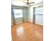 Cozy bedroom with laminate floors, light walls, and bright windows for ample natural light at 1604 Chevy Chase Dr, Sun City Center, FL 33573