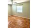 Bedroom with laminate floors and a bright window, creating a comfortable living space at 1604 Chevy Chase Dr, Sun City Center, FL 33573