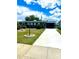 Charming single-story home with a well-manicured lawn and a long driveway leading to a covered carport at 1604 Chevy Chase Dr, Sun City Center, FL 33573
