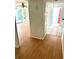 Hallway and transition space in the home with light-colored wood floors and white walls at 1604 Chevy Chase Dr, Sun City Center, FL 33573