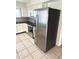 Well-equipped kitchen featuring stainless steel appliances, granite countertops, and bright white cabinetry at 1604 Chevy Chase Dr, Sun City Center, FL 33573
