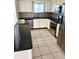 Updated kitchen with stainless steel appliances, granite countertops, white cabinets, and tile floors at 1604 Chevy Chase Dr, Sun City Center, FL 33573