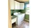Laundry room with washer, dryer, wash basin, and overhead cabinets at 1604 Chevy Chase Dr, Sun City Center, FL 33573