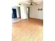 This is an expansive living room with light-colored wood floors and a ceiling fan at 1604 Chevy Chase Dr, Sun City Center, FL 33573
