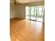 Bright living room featuring beautiful laminate flooring and sliding glass doors to a lanai at 1604 Chevy Chase Dr, Sun City Center, FL 33573