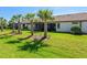 Beautiful backyard with lush green grass and mature palm trees perfect for outdoor enjoyment at 17612 Northwood St, Lakewood Ranch, FL 34202
