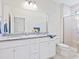 Bright bathroom featuring double sinks, granite countertops, and a separate glass-door shower at 17612 Northwood St, Lakewood Ranch, FL 34202