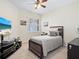 Brightly lit bedroom featuring a decorative ceiling fan and a comfortable-looking bed at 17612 Northwood St, Lakewood Ranch, FL 34202