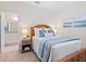 Cozy bedroom featuring a decorative blue and white throw and view into the bathroom at 17612 Northwood St, Lakewood Ranch, FL 34202