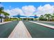 Well-manicured bocce ball courts with covered seating areas and lush greenery in a community setting at 17612 Northwood St, Lakewood Ranch, FL 34202
