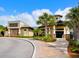 Inviting clubhouse exterior with stone accents, lush landscaping, and a circular driveway at 17612 Northwood St, Lakewood Ranch, FL 34202