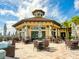 Outdoor patio with tables, umbrellas, and views of lush landscaping in a community setting at 17612 Northwood St, Lakewood Ranch, FL 34202