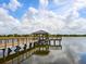 Scenic view of the wooden dock featuring a covered gazebo overlooking the tranquil lake at 17612 Northwood St, Lakewood Ranch, FL 34202