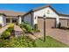 Charming home with a two-car garage, brick driveway, and well-maintained landscaping at 17612 Northwood St, Lakewood Ranch, FL 34202