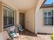Inviting front porch with brick pavers, comfortable seating, and stylish window shutters at 17612 Northwood St, Lakewood Ranch, FL 34202