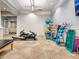 Well-equipped exercise room with weight racks, rowing machines, yoga accessories, and textured accent wall at 17612 Northwood St, Lakewood Ranch, FL 34202
