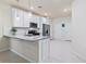Modern kitchen with white cabinets, granite countertops, stainless steel appliances, and ample counter space at 17612 Northwood St, Lakewood Ranch, FL 34202