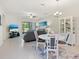 Bright living room featuring tile floors, modern furnishings, and sliding glass doors to the outdoors at 17612 Northwood St, Lakewood Ranch, FL 34202