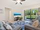 Relaxing living room with cozy seating, a marble table, and sliding doors to the patio at 17612 Northwood St, Lakewood Ranch, FL 34202