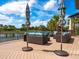 Relaxing outdoor lounge area with comfortable seating, umbrellas, and scenic views of a lake and landscape at 17612 Northwood St, Lakewood Ranch, FL 34202