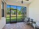 Screened-in patio featuring brick flooring, ceiling fan, and comfortable seating, perfect for relaxation at 17612 Northwood St, Lakewood Ranch, FL 34202