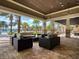 Outdoor patio featuring comfortable seating and scenic views of the pool and palm trees at 17612 Northwood St, Lakewood Ranch, FL 34202