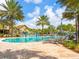 Resort-style community pool surrounded by lush tropical landscaping, lounge chairs and seating areas at 17612 Northwood St, Lakewood Ranch, FL 34202