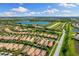 Aerial view featuring a residential community with scenic ponds, walking paths, and lush green spaces at 19023 Mangieri St, Venice, FL 34293