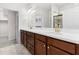 Bathroom featuring double sinks, white countertop, and wood cabinets at 19023 Mangieri St, Venice, FL 34293