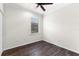 Well-lit bedroom featuring a ceiling fan, a window, and dark-stained wood floors at 19023 Mangieri St, Venice, FL 34293