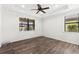 Spacious bedroom featuring a ceiling fan, crown molding and dark wood-look floors at 19023 Mangieri St, Venice, FL 34293
